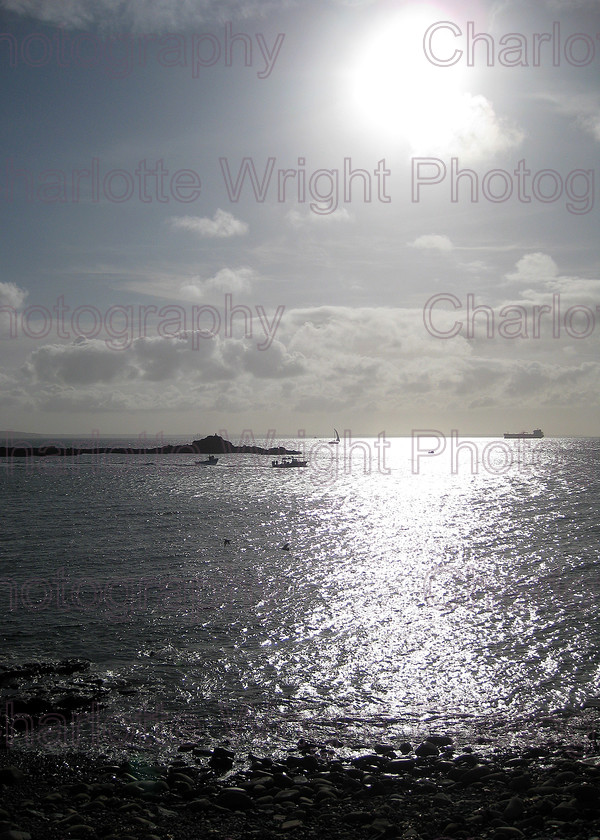 IMG 1940 
 Looking from Mousehole's harbour walls, out to St Clement's Isle in Cornwall. Shot straight into the sunlight, but that just made it more impressive a view. Photographed by myself, Charlotte Wright Photography 
 Keywords: Mousehole, St Clement's isle, cornwall, sea, sunlight, water, United Kingdom, photography
