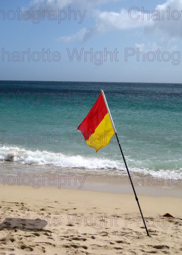 IMG 1389 
 A lifeguard's flag on a beach in Cornwall. I don't think anyone took any notice of it though! Photographed by myself, Charlotte Wright Photography 
 Keywords: flag, beach, sea, sand, waves, lifeguard, United Kingdom, photography